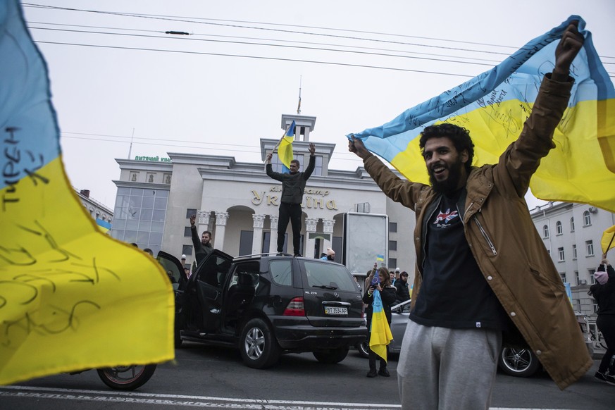 Ukrainians gather in downtown to celebrate the recapturing their city, Kherson, Ukraine, Saturday, Nov. 12, 2022. People across Ukraine awoke from a night of jubilant celebrating after the Kremlin ann ...