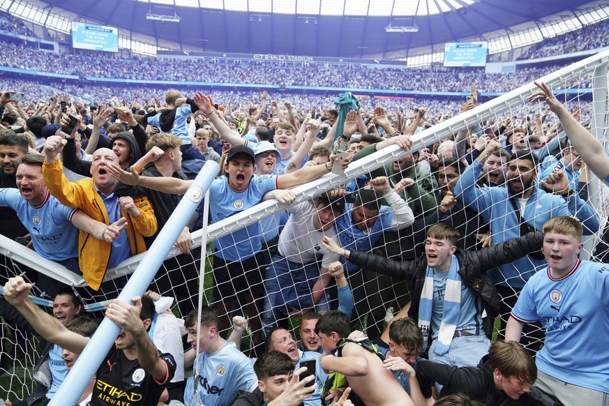 Manchester City fans invade the pitch after their side won the English Premier League following a 3-2 victory over Aston Villa at The Etihad Stadium, Manchester, England, Sunday, May 22, 2022. (Martin ...