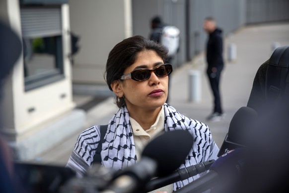 epa12867072 French MEP Rima Hassan talks to media as she arrives at the Paris Police Prefectures Criminal Investigation Department, where Hassan is due to be questioned for a second time on suspicion ...