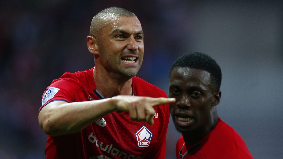 Lille's Burak Yilmaz, left, celebrates after Lille's Benjamin Andre scored his side's second goal during the French League One soccer match between Lille and Reims at the Stade Pierre M ...