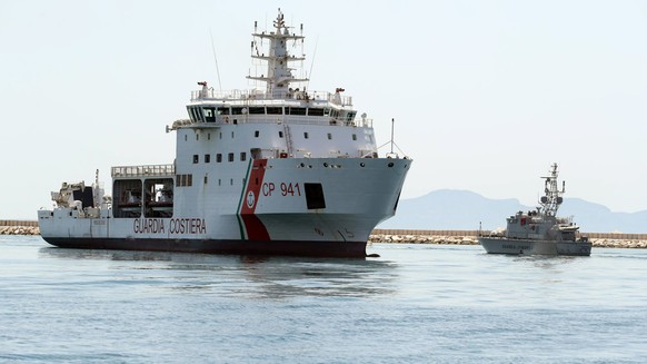 epa06883437 Italian Coast Guard ship Diciotti with 67 migrants on board enters the port of Trapani, Sicily, Italy, 12 July 2018. According to reports, the migrants were rescued by a civilian ship, the ...