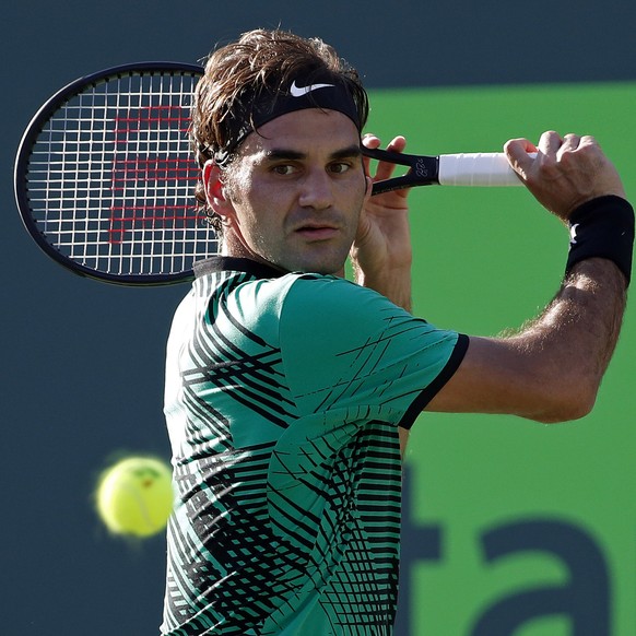 Mar 28, 2017; Miami, FL, USA; Roger Federer of Switzerland hits a backhand against Roberto Bautista Agut of Spain (not pictured) on day eight of the 2017 Miami Open at Crandon Park Tennis Center. Mand ...