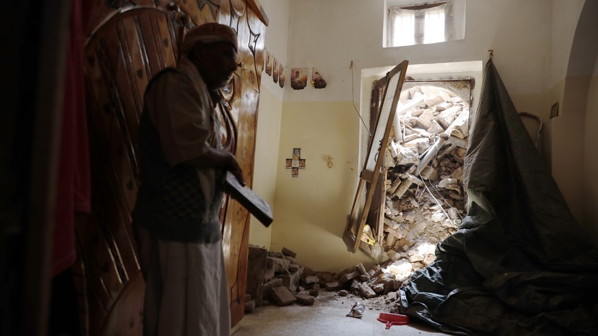 epa10114283 A Yemeni inspects a rains-collapsed UNESCO-listed building in the old quarter of Sana&#039;a, Yemen, 10 August 2022. Torrential rains have hit Yemen over the past two weeks, causing damage ...