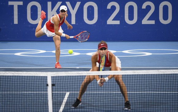 Belinda Bencic, right, and Viktorija Golubic, left, of Switzerland return a ball to Carla Suarez Navarro and Garbine Muguruza of Spain during the women&#039;s doubles tennis second round match at the  ...