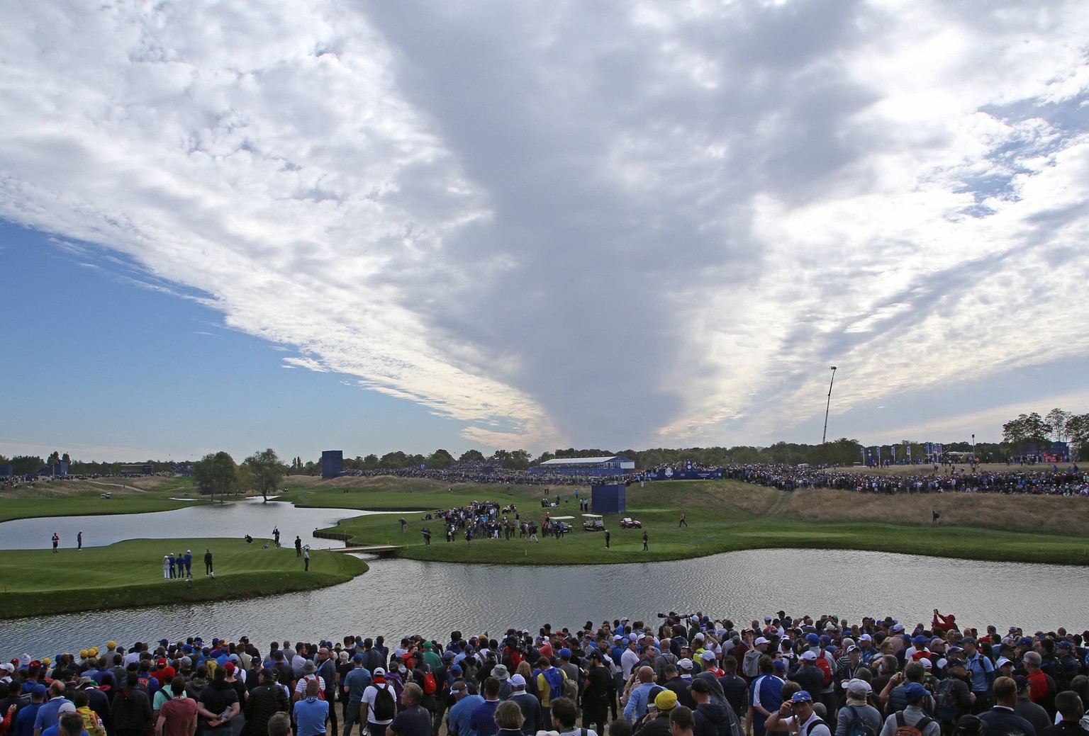 Clouds cover players and fans at the Ryder Cup at Le Golf National in Guyancourt near Paris on September 30, 2018. Team Europe defeated Team USA 17.5 to 10.5 to hand the Americans their sixth straight ...