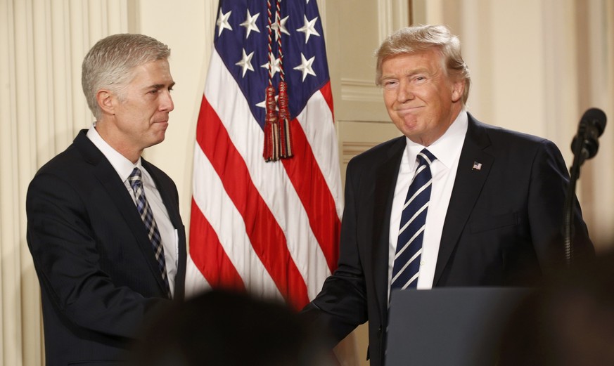 U.S. President Donald Trump shakes hands with Neil Gorsuch (L) after nominating him to be an associate justice of the U.S. Supreme Court at the White House in Washington, D.C., U.S., January 31, 2017. ...