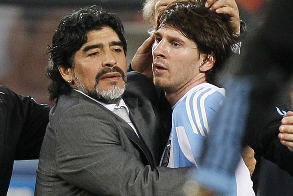 FILE - The July 3, 2010 file photo shows Argentina's Lionel Messi, right, as he is comforted by Argentina head coach Diego Maradona, left, following the World Cup quarterfinal soccer match betwee ...