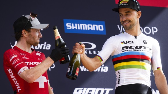 Second placed Mathias Flueckiger of Switzerland, left, and winner Nino Schurter of Switzerland, after the UCI Cross Country Mountain Bike World Cup, on Sunday, July 2, 2023, in Val di Sole, Italy. (KE ...
