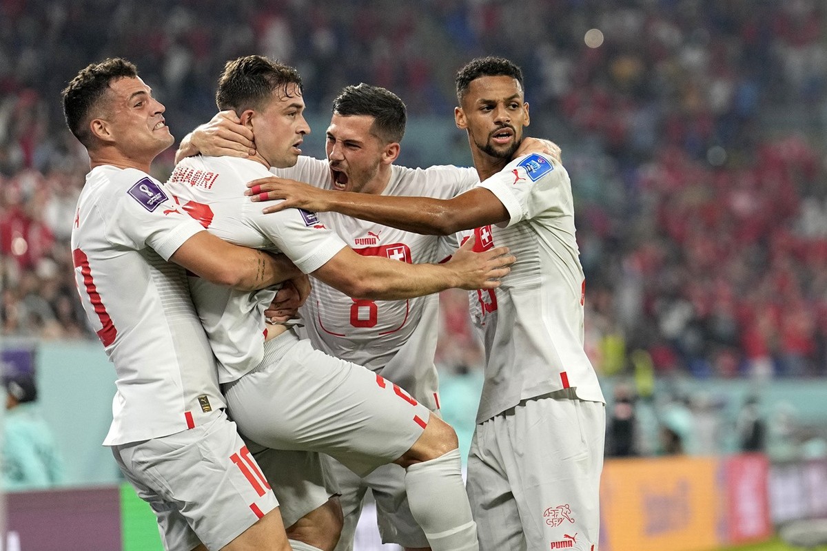 Switzerland's Xherdan Shaqiri, second left, celebrates with teammates after scoring his side's opening goal during the World Cup group G soccer match between Serbia and Switzerland, at the S ...