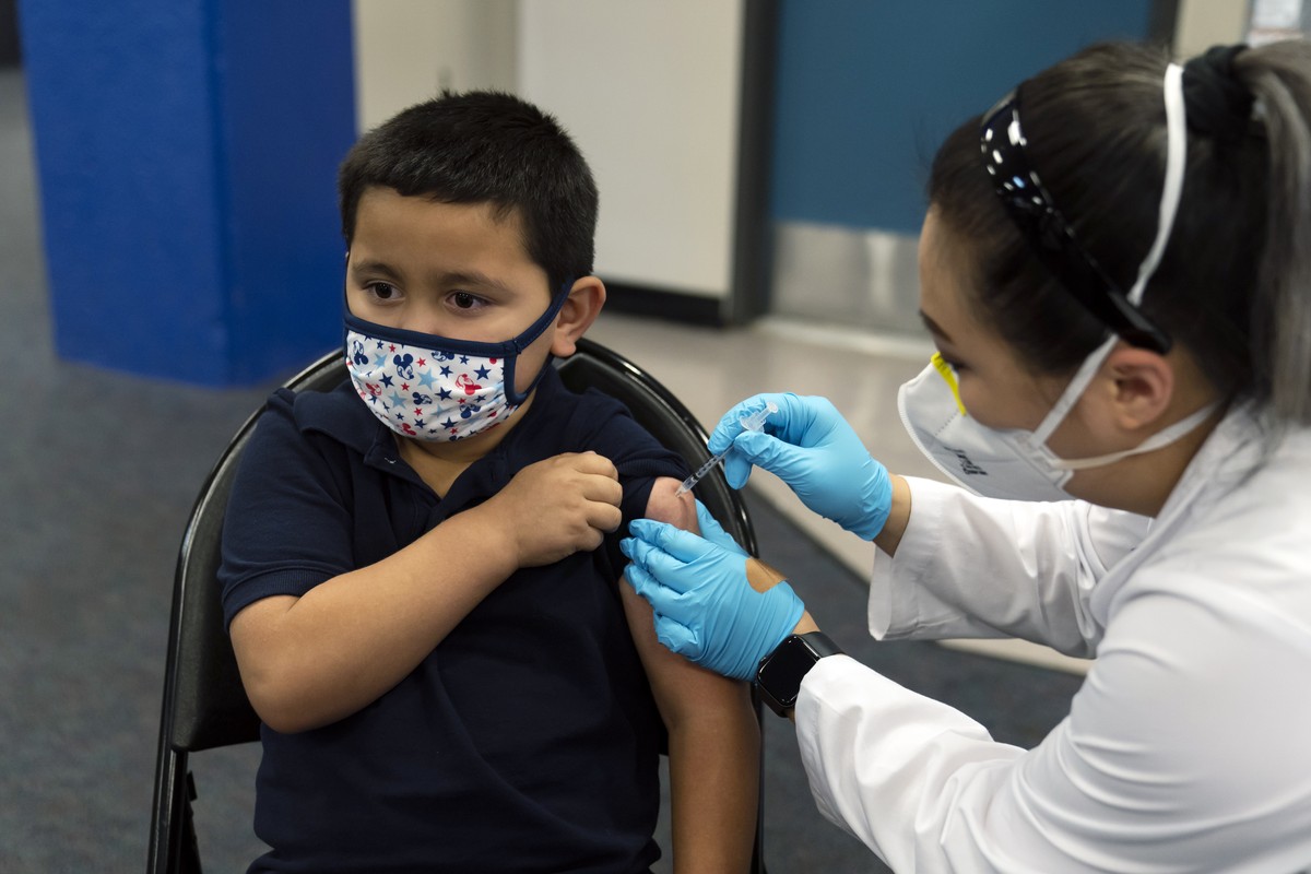 FILE - Six-year-old Eric Aviles receives the Pfizer COVID-19 vaccine from pharmacist Sylvia Uong at a pediatric vaccine clinic for children ages 5 to 11 set up at Willard Intermediate School in Santa  ...