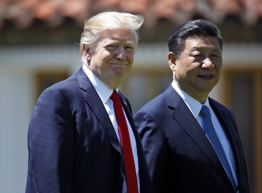 President Donald Trump and Chinese President Xi Jinping walk together after their meetings at Mar-a-Lago, Friday, April 7, 2017, in Palm Beach, Fla. Trump was meeting again with his Chinese counterpar ...