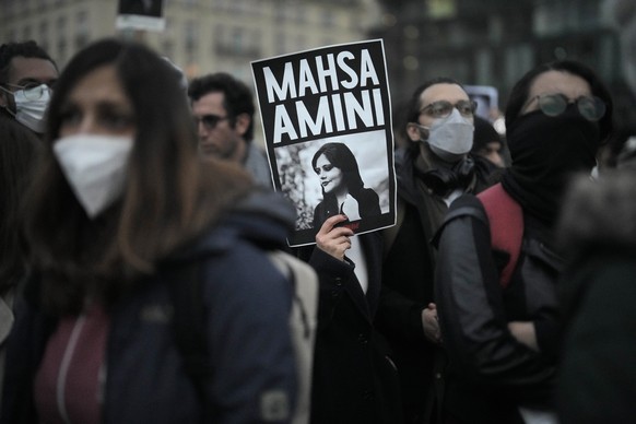 FILE - A woman shows a placard with a photo of of Iranian Mahsa Amini as she attends a protest against her death, in Berlin, Germany, Wednesday, Sept. 28, 2022. Amini&#039;s death in custody has spark ...