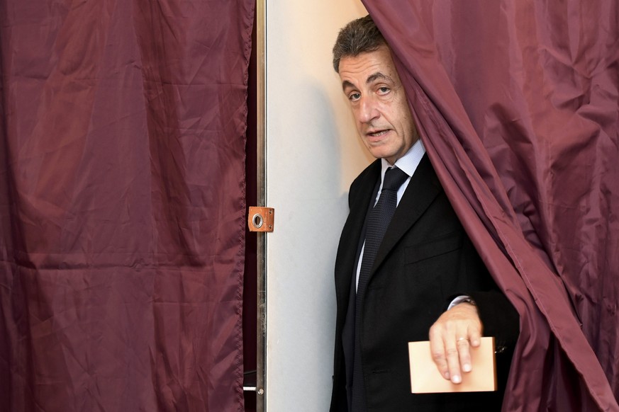 Nicolas Sarkozy, former French president and candidate for the French conservative presidential primary, votes in the first round of the French center-right presidential primary election in Paris, Fra ...