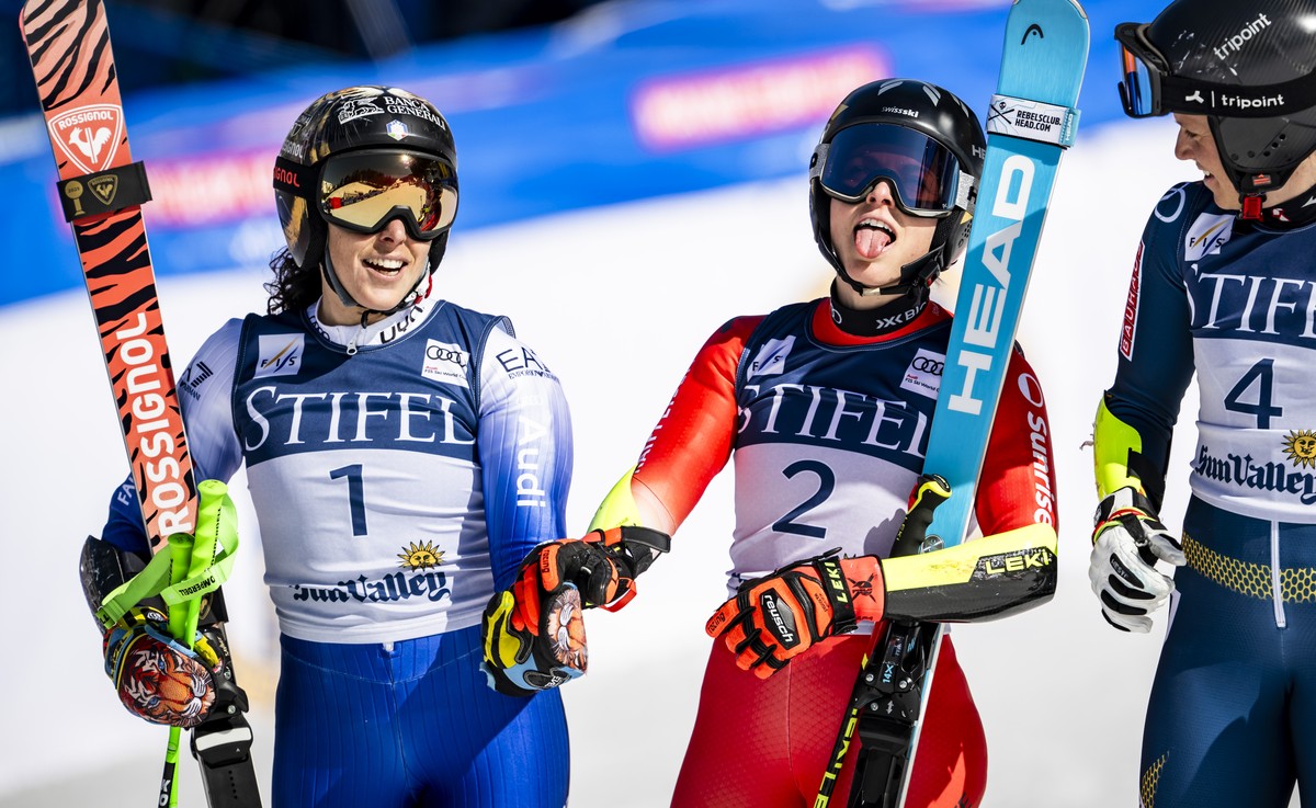 Federica Brignone of Italy, left, and Lara Gut-Behrami of Switzerland, center, and Sara Hector of Sweden, right, react in the finish area second run of the women's Giant Slalom race at the FIS Al ...