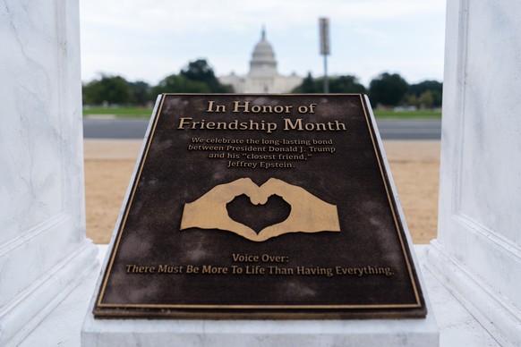A work of protest art representing President Donald Trump and Jeffrey Epstein is seen on the National Mall near the Capitol, Tuesday, Sept. 23, 2025, in Washington. (AP Photo/Julia Demaree Nikhinson)
 ...