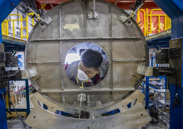 epaselect epa08740188 A man works in Hiwing Aviation factory in Zhenjiang, Jiangsu province, China, 13 October 2020. Hiwing Aviation Special Materials was established in 2011 and it is affiliated to t ...