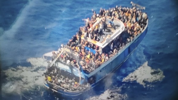 This undated handout image provided by Greece&#039;s coast guard on Wednesday, June14, 2023, shows scores of people covering practically every free stretch of deck on a battered fishing boat that late ...
