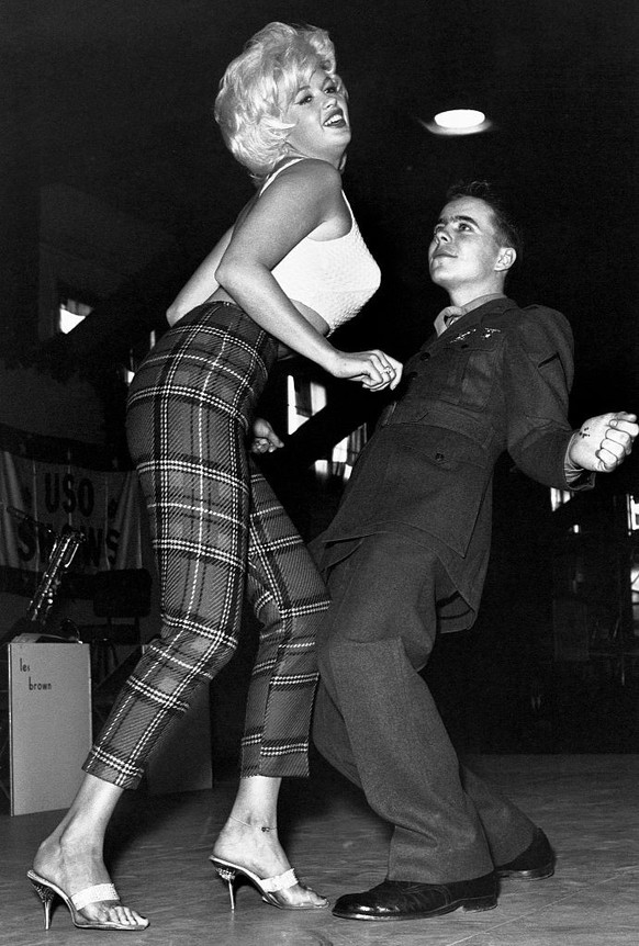 Marine Pfc. Bob Kamineki dances the twist with motion picture actress Jayne Mansfield at the U.S. Naval Station Argentia in Newfoundland, Canada. Mansfield traveled to the Arctic base with other Holly ...