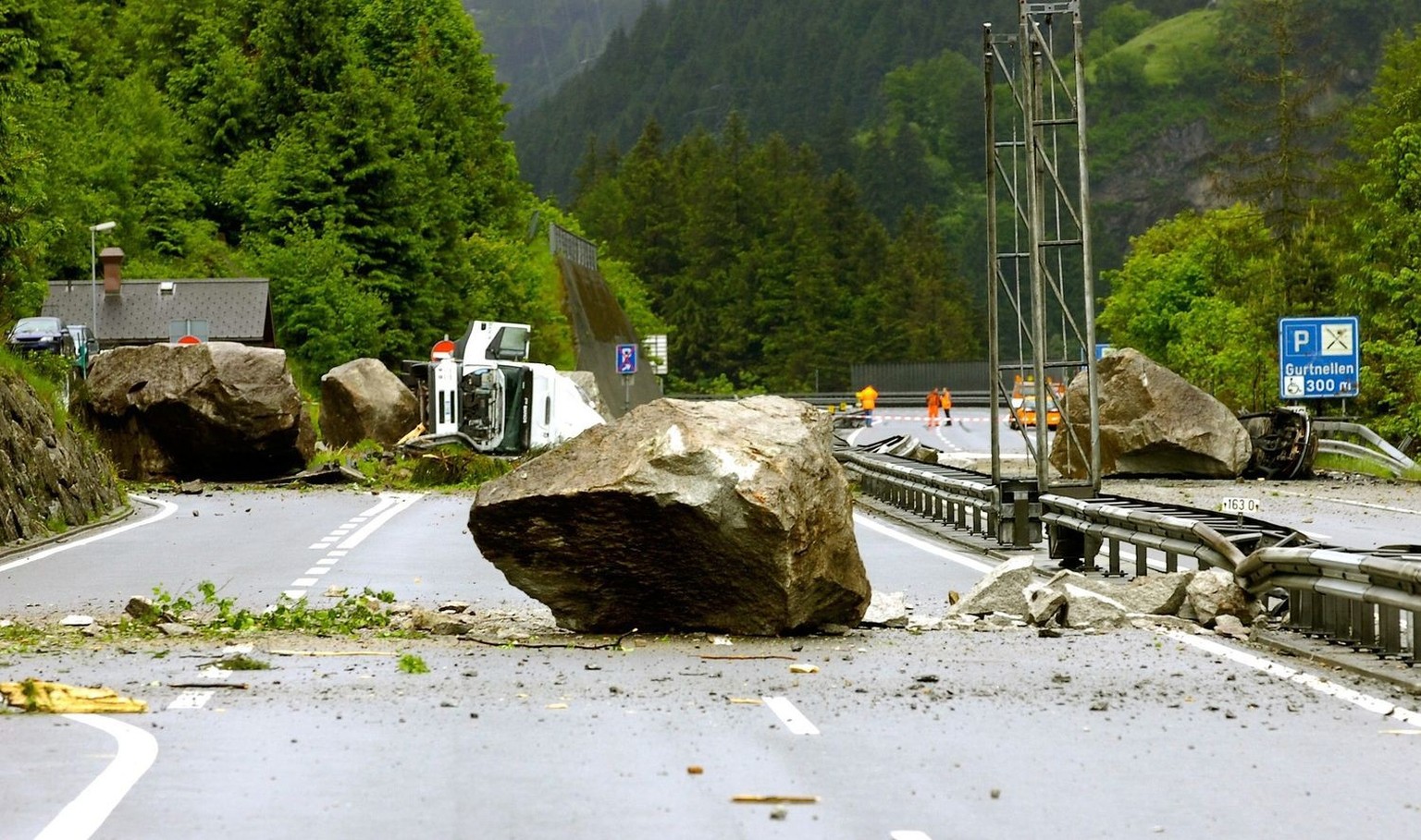 A truck, left, and a car, right, lie under giant rocks on the A2 Gotthard freeway near Gurtnellen, Canton of Uri, Wednesday, May 31, 2006. The two sleeping truckdrivers were hurt; two other persons in ...