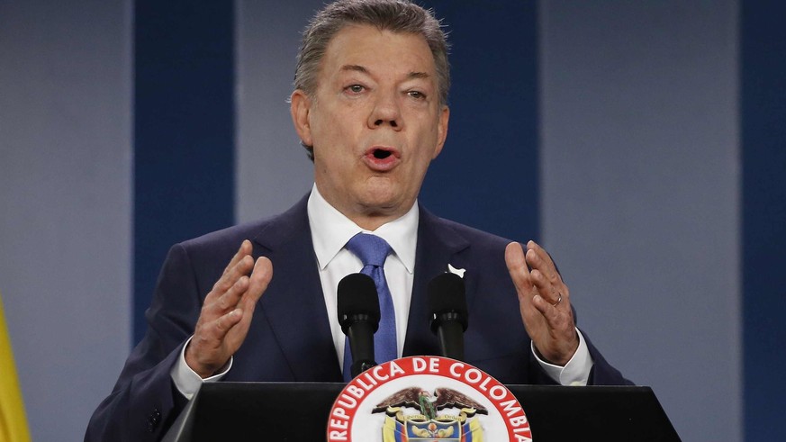 FILE - In this Wednesday, Oct. 4, 2016 file photo Colombia’s President Juan Manuel Santos delivers a statement to the press after meeting with former President Alvaro Uribe and other opposition leader ...