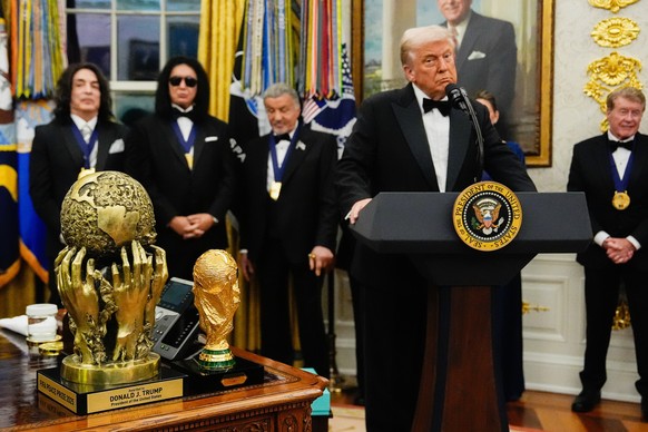 The FIFA Peace Prize is displayed on the Resolute Desk as President Donald Trump presents Sylvester Stallone, George Strait, Kiss, Gloria Gaynor and Michael Crawford with their Kennedy Center Honors m ...