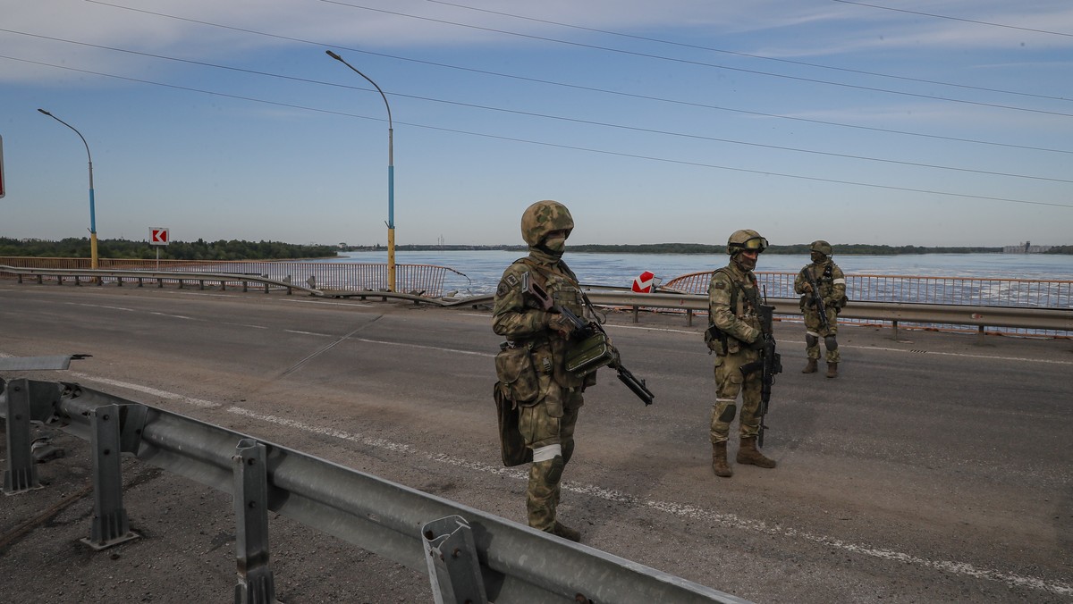 epa09962108 A picture taken during a media tour organized by the Russian Army shows Russian servicemen standing guard near the Kakhovka Hydroelectric Power Plant (HPP) on the Dnieper River in Kakhovka ...
