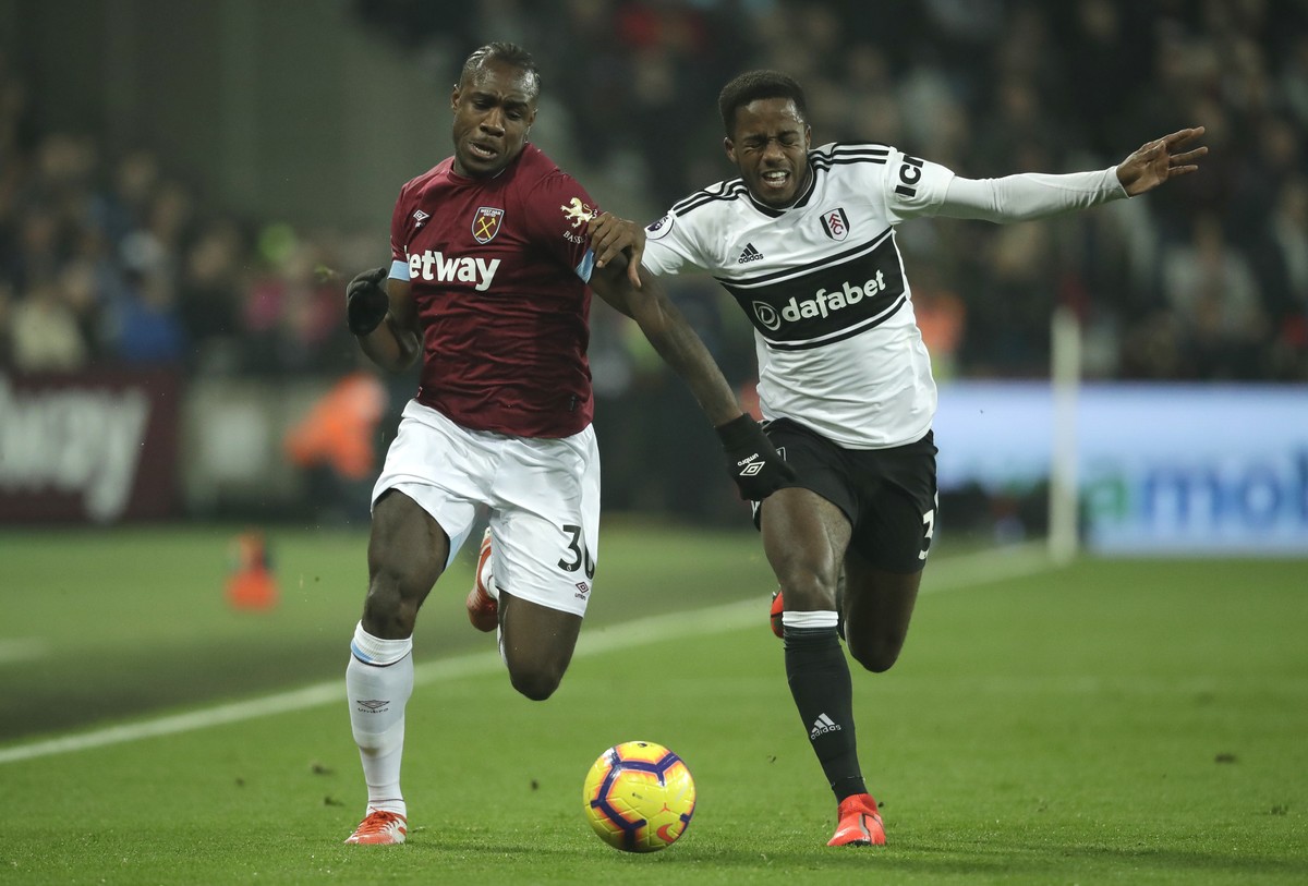 West Ham's Michail Antonio, left, vie for the ball with Fulham's Ryan Sessegnon during the English Premier League soccer match between West Ham and Fulham at the London Stadium in London, Fr ...
