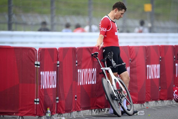 Fourth placed Stefan Kueng of Switzerland reacts after crossing the finish line during the men&#039;s cycling individual time trial at the 2020 Tokyo Summer Olympics at the Fuji International Speedway ...