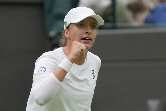 Poland&#039;s Iga Swiatek celebrates defetating China&#039;s Zhu Lin in the first round women&#039;s singles match on day one of the Wimbledon tennis championships in London, Monday, July 3, 2023. (AP ...
