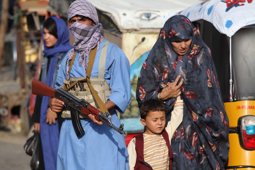 epa09342805 Armed supporters of former Mujahideen commander Khan, stand guard on a roadside checkpoint as they vow to fight side by side with the Afghan security forces to defend their regions in Hera ...