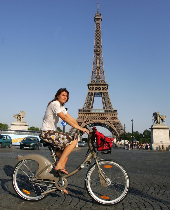 A rider uses a new bicycle provided by Paris City Hall, around the Eiffel Tower in Paris, Sunday, July 15, 2007. Paris City Hall launched a new bicycle service Sunday, with more than 10,600 posted at  ...