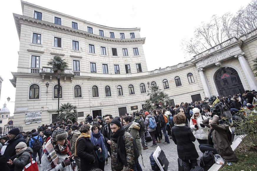 epa05727215 Students and teachers stand outside the Liceo art school and Belle Arti Academy after a 5.6 magnitude earthquake struck in Rome, Italy, 18 January 2017. The second earthquake that hit cent ...