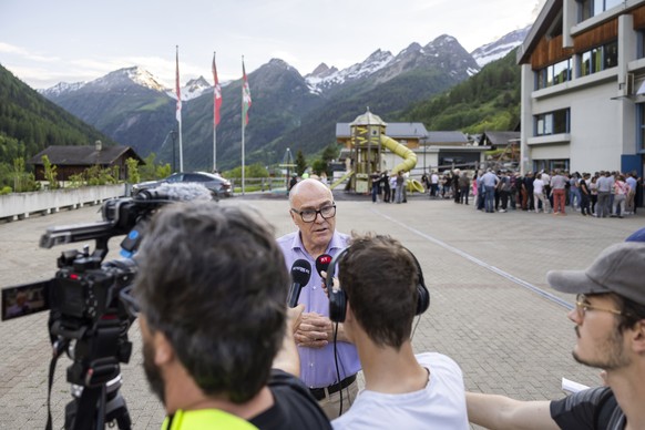 Swiss Federal Councillor Martin Pfister responds to journalists after speaking to the population in Wiler, Switzerland, Saturday, May 31, 2025. A large part of the village of Blatten, located in the L ...