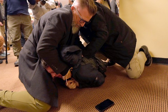 A man is tackled to the ground after spraying an unknown substance on U.S. Rep. Ilhan Omar, D-Minn., during a town hall on Tuesday, Jan. 27, 2026, in Minneapolis. (Richard Tsong-Taatarii/Star Tribune  ...