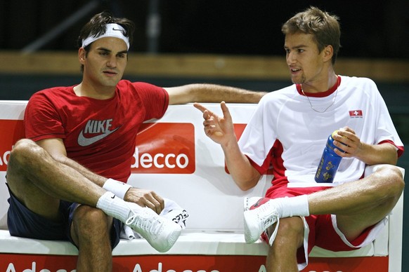 World number one tennis player Roger Federer of Switzerland, left, and teammate Marco Chiudinelli, right, speak together during the first training session before their Davis Cup World Group Play-offs  ...