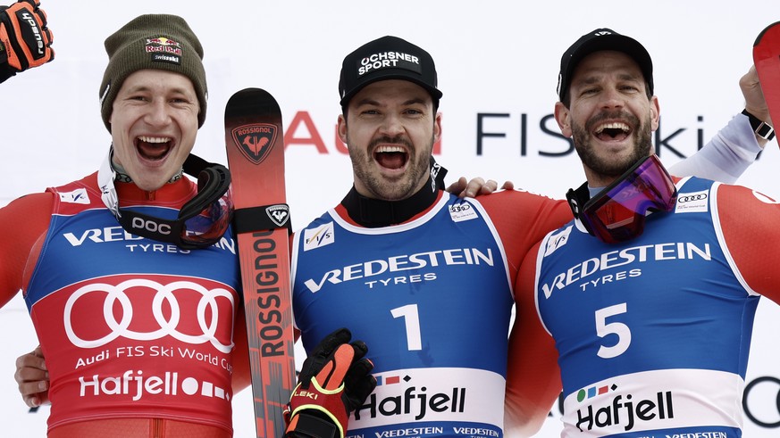 KEYPIX - Switzerland&#039;s Loic Meillard, center, winner of an alpine ski, men&#039;s World Cup Giant Slalom, celebrates on the podium with second-placed Switzerland&#039;s Marco Odermatt, left, and  ...