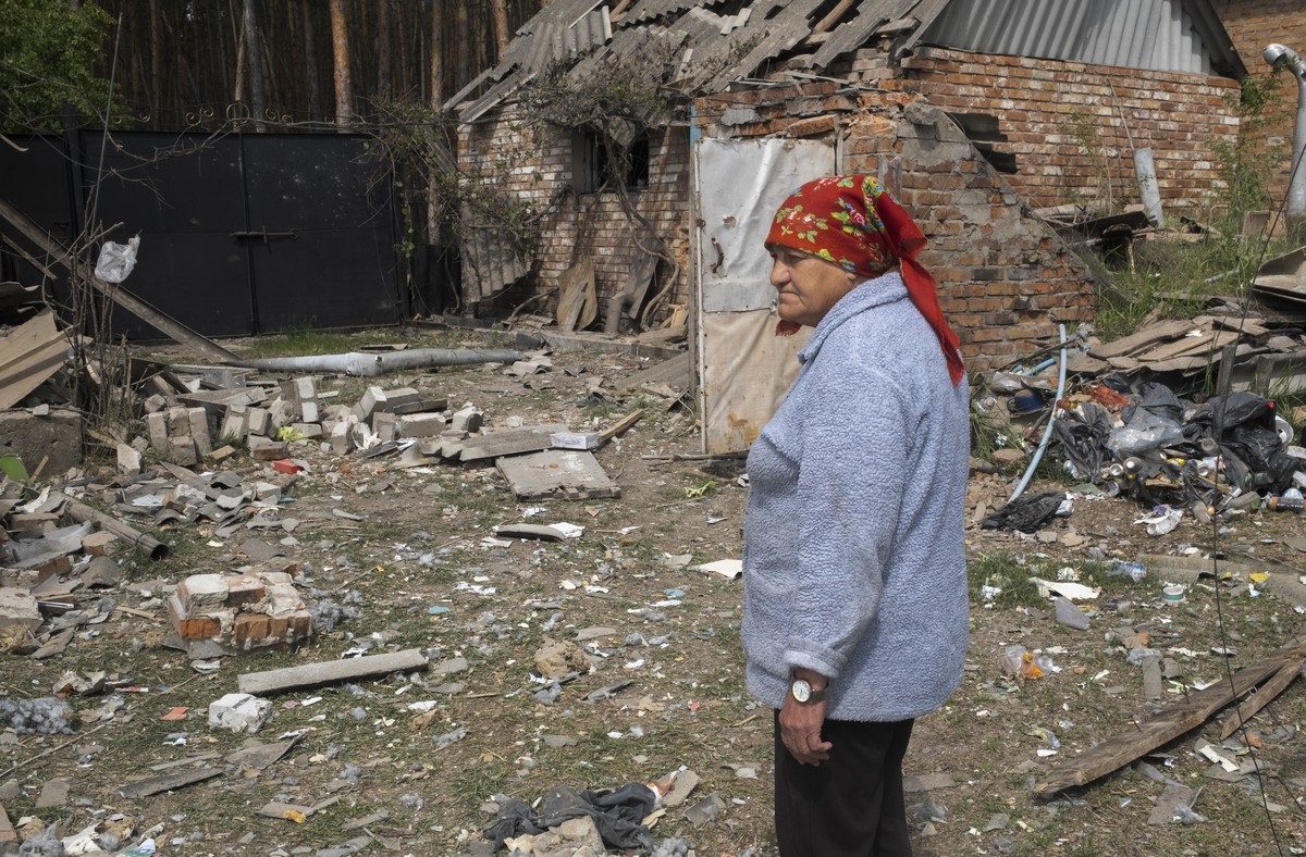 epa11333859 Lidia looks at the damage after shelling on the outskirts of Volchans, Kharkiv region, Ukraine, 11 May 2024, amid the Russian invasion. Lidia, along with others, decided not to evacuate bu ...