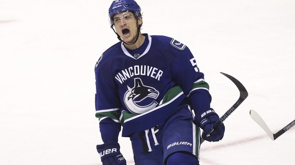 Vancouver Canucks&#039; Luca Sbisa (5) celebrates his goal against the Tampa Bay Lightning during the second period of an NHL hockey game in Vancouver, British Columbia, Friday, Dec. 16, 2016. (Ben Ne ...