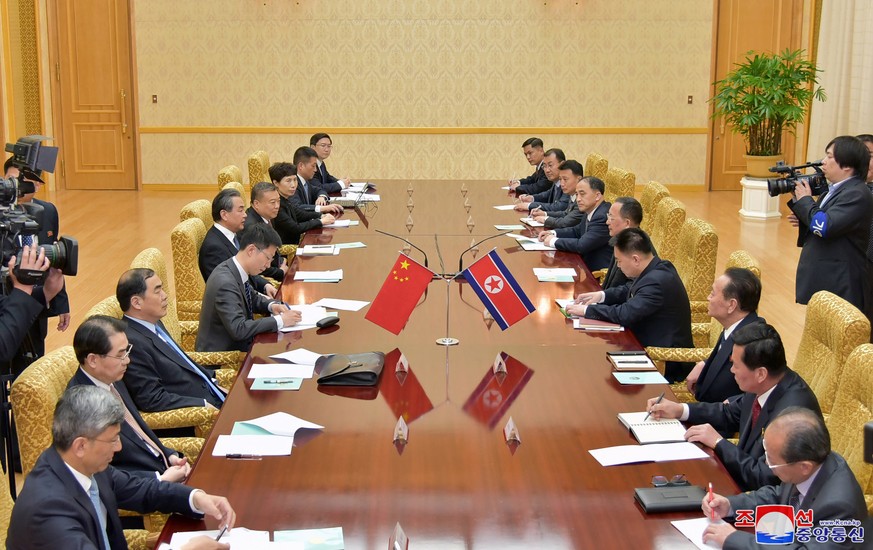 epa06708120 A photo released by the North Korean Central News Agency (KCNA), the state news agency of North Korea, shows Ri Yong Ho, foreign minister of North Korea, and Wang Yi, state councilor and f ...