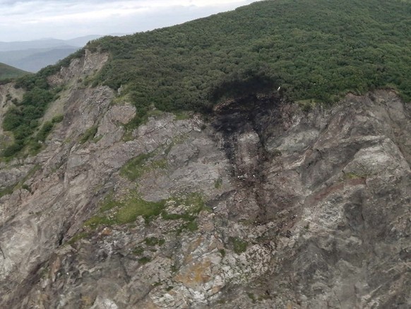 This photo released by the Russia Emergency Situations Ministry press service on Wednesday, July 7, 2021, shows wreckage of a missing Antonov An-26 missing plane found near its destination airport out ...