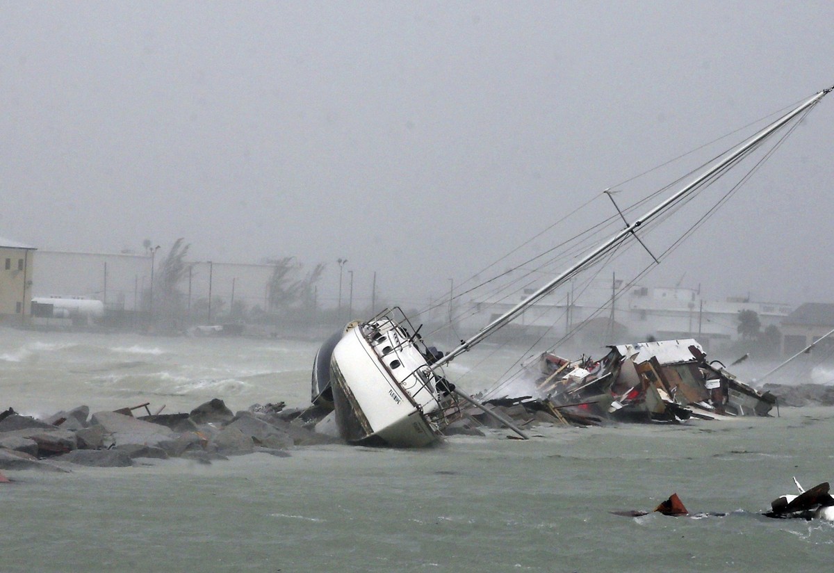 In this Sunday, Sept. 10, 2017, photo, a sailboat crashes on the shore near Mallory Square as Hurricane Irma moves into the Florida Straits on Key West, Fla. (Charles Trainor Jr/Miami Herald via AP)
