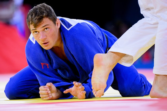 Daniel Eich of Switzerland, in blue, reacts during the fight against Peter Paltchik of Israel, in white, during the judo men&#039;s -100kg bronze medal contest at the 2024 Paris Summer Olympics in Par ...
