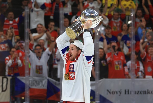 epa11372597 Czech Republic&#039;s Roman Cervenka celebrates with the trophy after winning the gold medal match between Switzerland and Czech Republic at the IIHF Ice Hockey World Championship 2024 at  ...