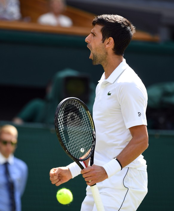 epa07687326 Novak Djokovic of Serbia celebrates a winner against Philipp Kohlschreiber of Germany in their first round match during the Wimbledon Championships at the All England Lawn Tennis Club, in  ...