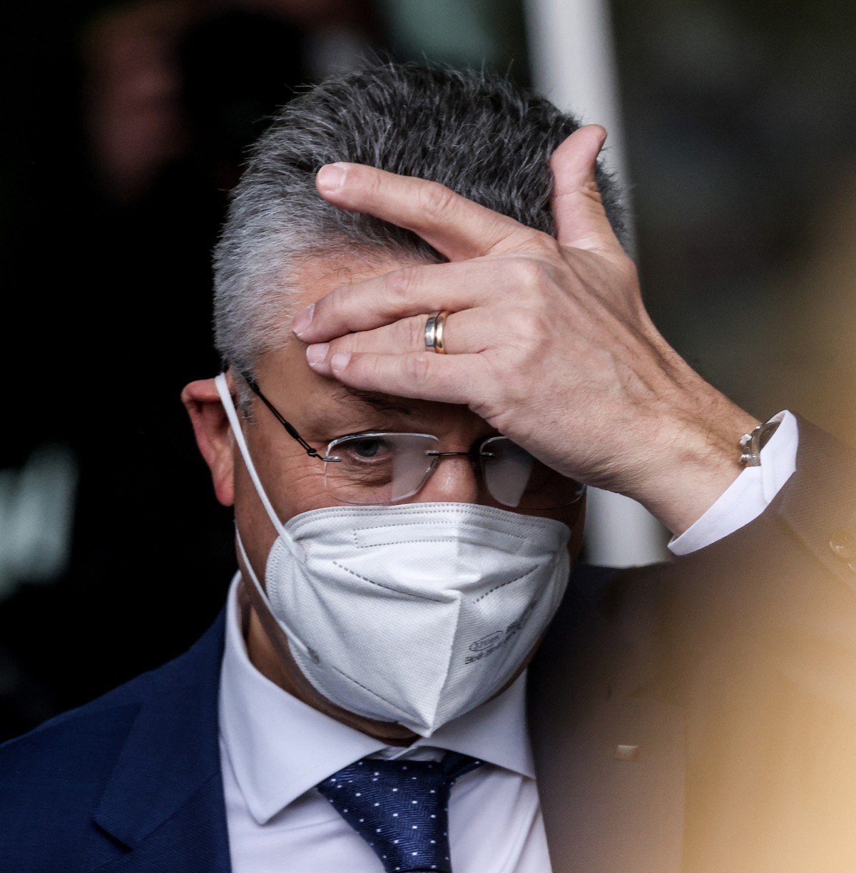epa09604363 Head of Robert Koch Institute Lothar Wieler reacts after a press conference about the current pandemic Covid-19 situation, in Berlin, Germany, 26 November 2021. As the number of infections ...