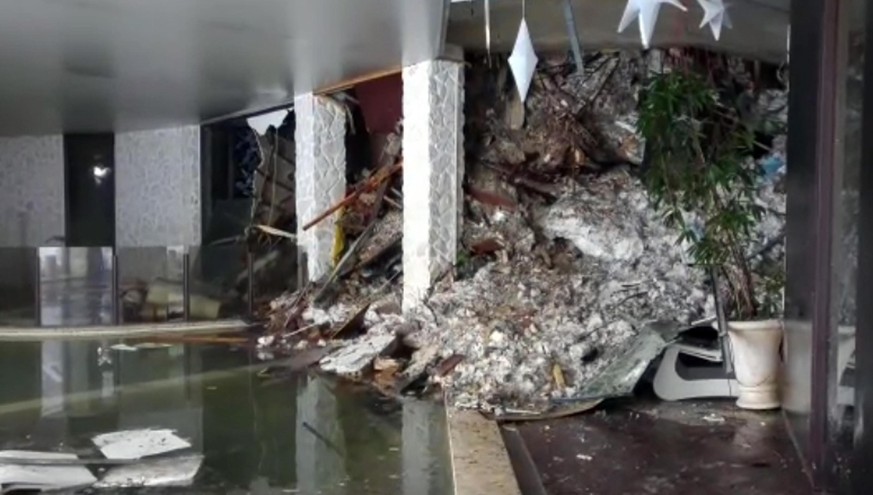 This photo taken from a video shows show piles of snow and rubble cascading down the stairway into the foyer of the hotel Rigopiano in Farindola, Italy, early Thursday, Jan. 19, 2017. A hotel in the m ...