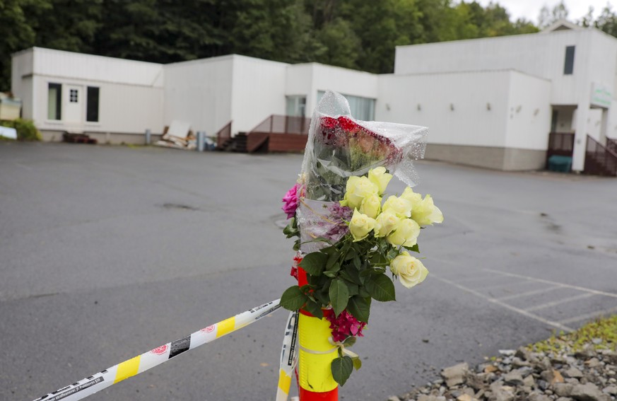 Flowers are left by a police cordon outside Al-Noor Islamic Centre Mosque in Baerum, Norway, Monday Aug. 12, 2019, after an attack at the mosque on Saturday. The defense lawyer for a suspected gunman  ...