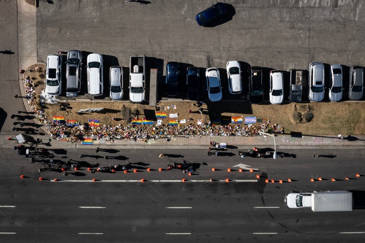 COLORADO SPRINGS, CO - NOVEMBER 22: In this aerial view, mourners gather at a memorial on the street in front of Club Q on November 22, 2022 in Colorado Springs, Colorado. A gunman opened fire inside  ...