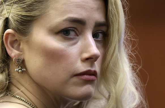 Actor Amber Heard waits before the verdict was read at the Fairfax County Circuit Courthouse in Fairfax, Va, Wednesday, June 1, 2022. The jury awarded Johnny Depp more than $10 million in his libel la ...