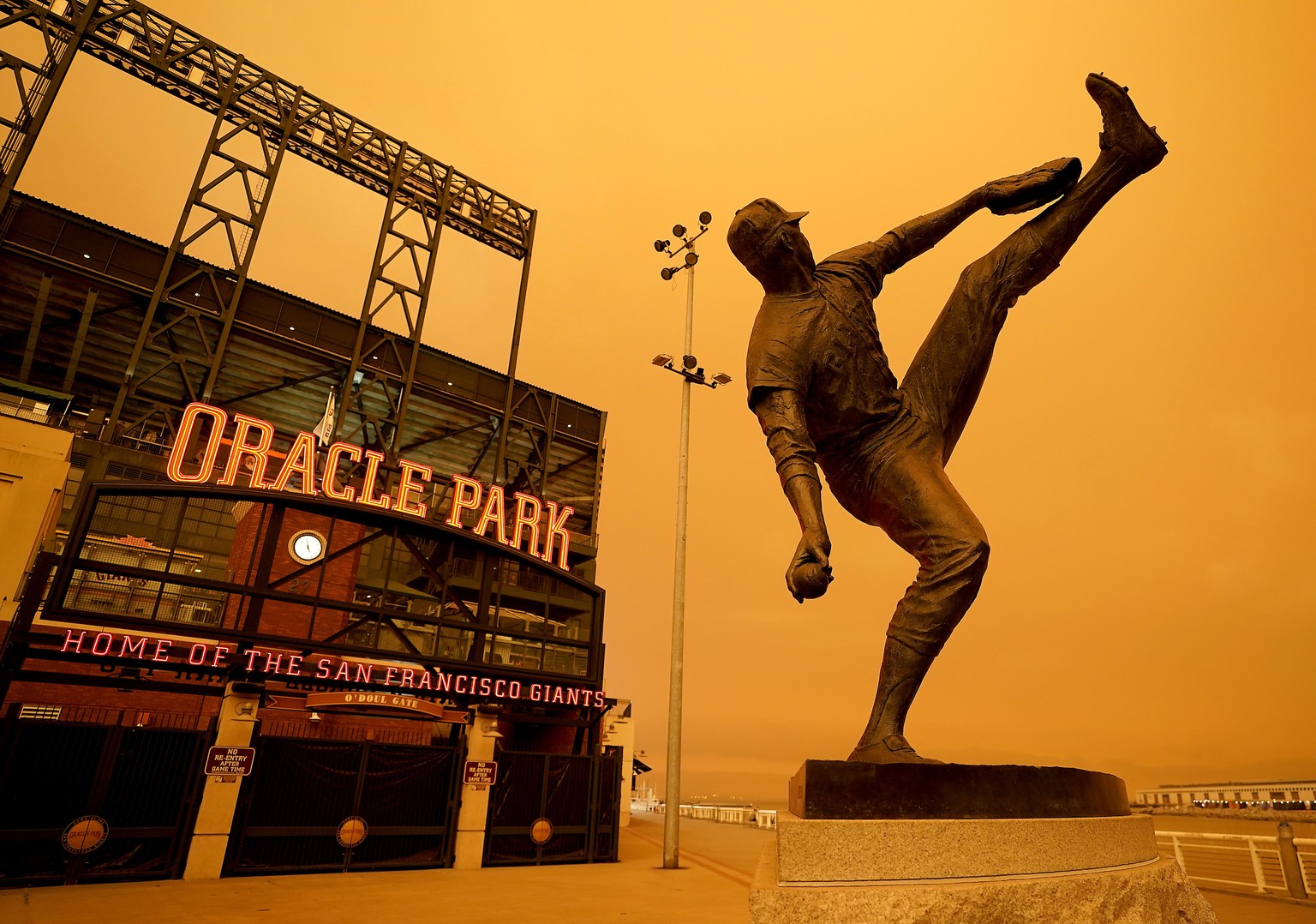 Wildfire smoke darkens the sky over a statue of former San Francisco Giants pitcher Juan Marichal outside Oracle Park before a baseball game between the Giants and the Seattle Mariners on Wednesday, S ...